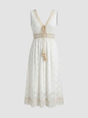 White lace maxi dress with V-neck, tassel ties, and crochet trim, front view.