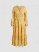 Yellow long sleeve mini dress with gold polka dots and lace trim, front view.