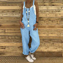 Light blue denim overall with star necklace, front view on wooden background.