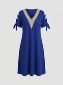 Royal blue V-neck dress with beige crochet trim and tie sleeves, front view on a white background.
