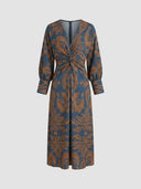 Blue maxi dress with brown abstract floral pattern, V-neck, twisted front, front view.