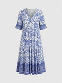 White and blue floral maxi dress with V-neck and ruffled sleeves, front view on a white background.