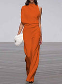 Orange sleeveless crew neck jumpsuit with wide legs, front view on a runway.
