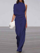 Navy blue sleeveless crew neck jumpsuit with wide legs, front view on runway.