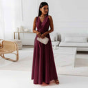 Burgundy sleeveless V-neck maxi dress with waist tie, front view on a white background.