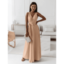 Peach sleeveless deep V-neck maxi gown with tie waist, front view in a modern room.