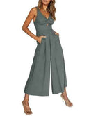 Gray wide-leg overall with V-neck, twisted front, and side pockets, front view on white background.
