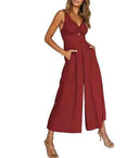 Red wide-leg overall with spaghetti straps and front knot detail, angled front view on white background.