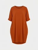 Rust orange mini shirt dress with rolled sleeves and side pockets, front view.