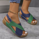 Navy and green colour-block flatform wedge sandals with cork-look platform sole, angled side view.