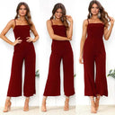 Maroon flared-leg jumpsuit with adjustable straps, front view on a white background.