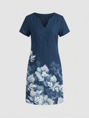Viola navy blue short sleeve mini shift dress with white border floral print on lower skirt and split V-neckline, front view.