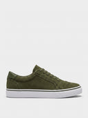 Olive green low-top canvas trainers with white rubber sole, lace-up closure and perforated upper detail, side view.