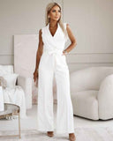 White sleeveless V-neck jumpsuit with integrated tassel tie belt, front view.