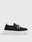 Platform slip-on trainer in black with gold curb-chain hardware and white platform sole — front view on white background.