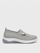 Light grey knit slip-on trainers with T-bar cut-out vamp and white midsoles, side view on white background.