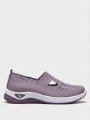 Lilac knit slip-on trainer with T-bar cut-out strap, chunky white midsole and purple rubber outsole, side view.