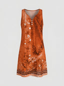 Orange sleeveless midi dress with white floral print and patterned hem, front view.