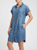 Blair Short Sleeve Denim Mini Shirt Dress in light blue, angled front view showing point collar, cuffed short sleeves, and button placket detail.