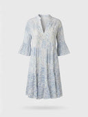 White and blue patterned mini dress with V-neck and bell sleeves, front view.