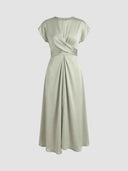 Sage green midi dress with twisted bodice and pleated skirt, front view on white background.