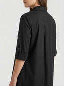 Agnes Summer Midi Shirt Dress in black — back view showing back pleats, tab-roll ¾ sleeves and mid-calf midi hem length on light background.