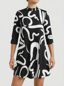 Alanna abstract print mini dress in black with bold white swirl pattern, mock collar neckline and three-quarter sleeves, front view