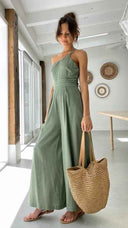Sage green asymmetrical strapless jumpsuit with high waistline, full body front view.