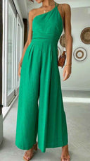 Green asymmetrical strapless jumpsuit with wide legs, front view.