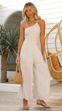 Beige asymmetrical strapless jumpsuit with high waistline, front view.