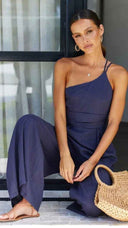 Navy blue asymmetrical strapless jumpsuit with high waistline, angled view.