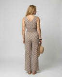 Tan jumpsuit with brown geometric pattern, wide waistband, back view on white background.