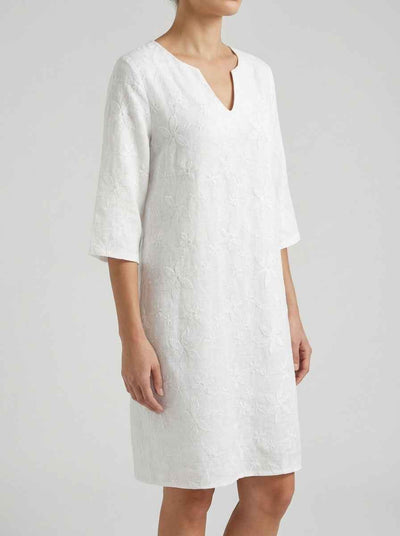 Amber Summer Mini Dress in White — V-notch neckline, three-quarter sleeves, all-over tone-on-tone floral embroidery, angled front view on grey background.
