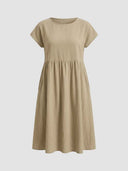Amelia cap sleeve empire midi dress in khaki showing side seam pockets, straight-on front view.
