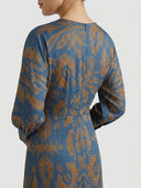 Amelia floral A-line midi dress in blue with amber botanical print, back view showing full-length bishop sleeves and midi hemline.