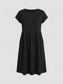 Black mini dress with short sleeves and empire waist, front view on light gray background.