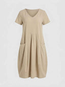Amelia V-neck cap sleeve midi dress in khaki, relaxed A-line with front patch pockets, front view on white background.