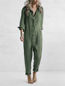 Olive green long-sleeve jumpsuit with button closure, front pockets, and rolled cuffs, front view.