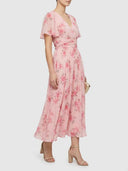 Pink floral V-neck midi dress with flutter sleeves and ruched waist, angled side view.