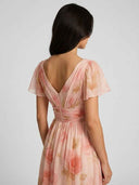 Pink floral dress with V-neck back, ruched waist, and short sleeves, back view.