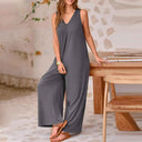 Gray baggy V-neck jumpsuit with side pockets, full front view.