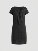 Beatrice cap sleeve bow detail mini dress in black, front view on light grey background showing bow-knot neckline and mini length.