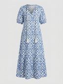 Beatrice Floral V-Neck Maxi Summer Dress in Light Blue with blue-and-white ikat floral print, tassel tie V-neckline and short sleeves, front view.