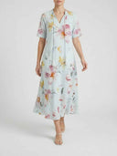 Beatrice Floral V-Neck Maxi Summer Dress in Sky Blue, close view of tassel tie V-neck detail and full-length A-line floral skirt, front view on white background.
