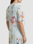 Beatrice Floral V-Neck Maxi Summer Dress in Sky Blue with pink and yellow watercolour floral print, back angled view showing A-line skirt.
