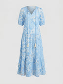 Beatrice Floral V-Neck Maxi Summer Dress in Sky Blue with white floral print, A-line maxi length and V-neck tassel tie, front view.