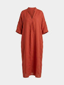 Beatrice linen-look maxi dress in rust terracotta, front view showing notched V-neckline with mandarin collar, tab-roll three-quarter sleeves, and relaxed boxy silhouette.