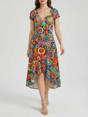 Bella multicolour circle print high-low mini dress showing the full asymmetric midi-sweep hem from front angle on white background.