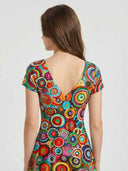 Bella circle print high-low mini dress rear view on model, showing midi-length back sweep, V-neckline detail and vibrant all-over abstract print.