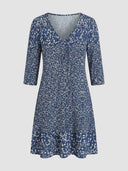 Bella navy blue printed mini dress with V-neckline and 3/4 sleeves, front view on grey background